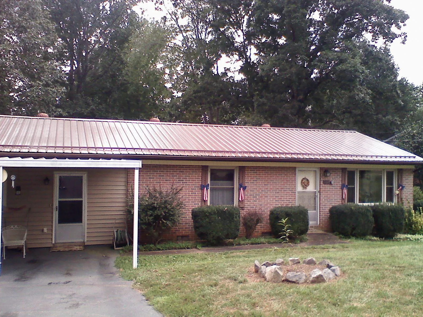 Bronze metal roof and carport on a brick ranch home — Roof Repair work by our crew in Adamstown