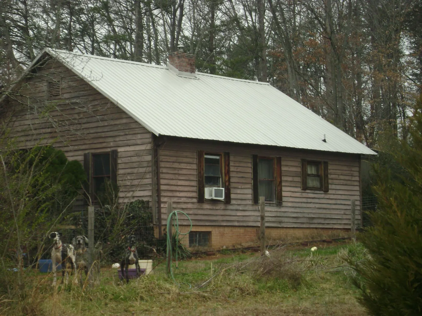 White metal roof on an old wood sided farmhouse, from a Metal Roof Installation job in Adamstown